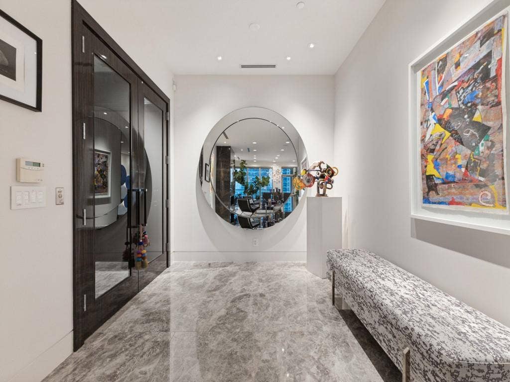 2300 Wolf Street, #14A, Dallas, TX 75201 Entryway featuring large format grey-veined tile flooring, a circular mirror, and recessed lighting
