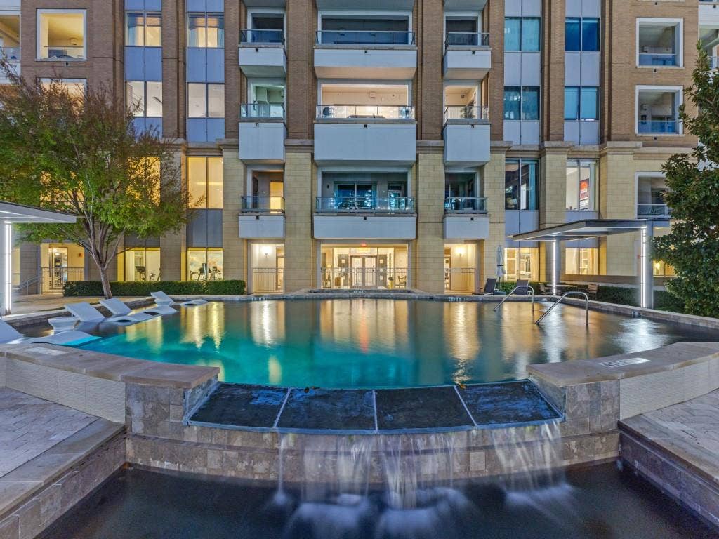 2300 Wolf Street, #14A, Dallas, TX 75201 Infinity-edge pool with integrated waterfall feature, surrounded by stone-clad hardscaping