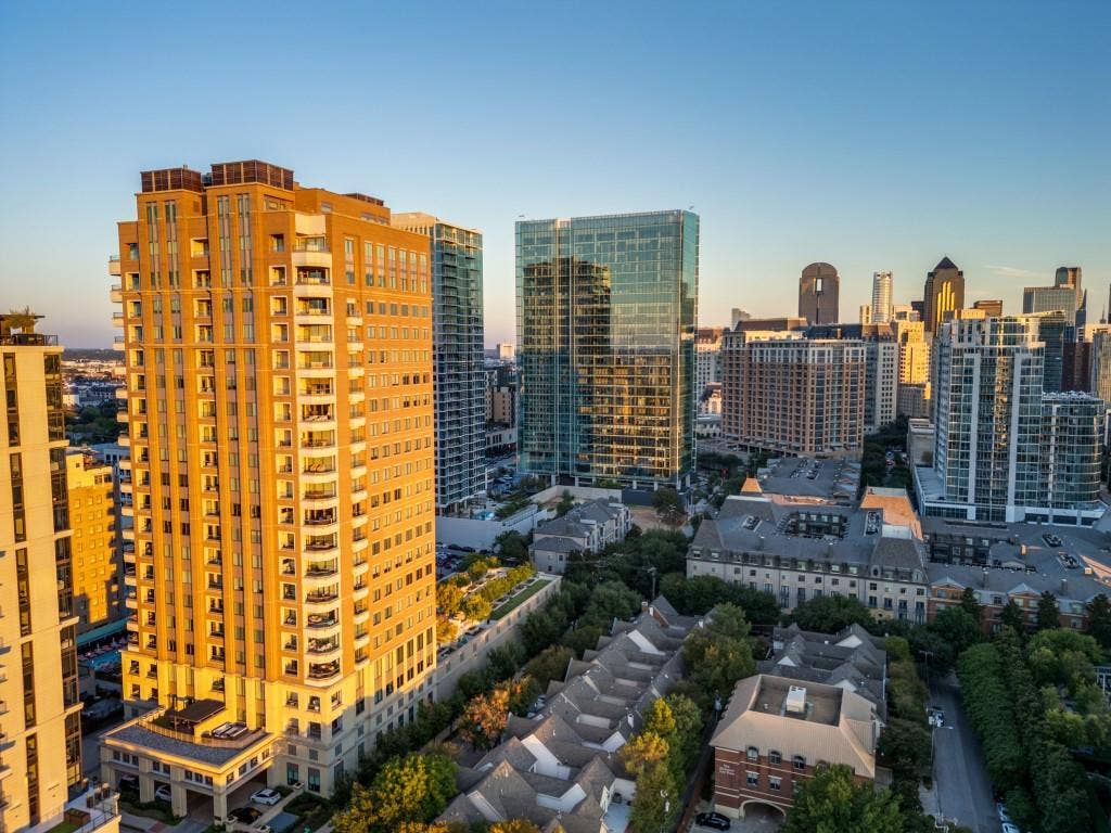 2300 Wolf Street, #14A, Dallas, TX 75201 High-rise building with extensive balconies, brick facade, and a flat roofline