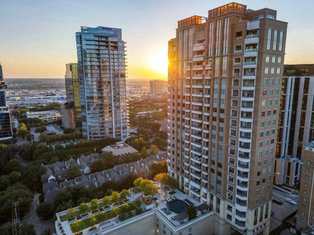 2300 Wolf Street, #14A, Dallas, TX 75201 Urban high-rise building featuring multiple balconies and rooftop amenities including a pool area and landscaped green space
