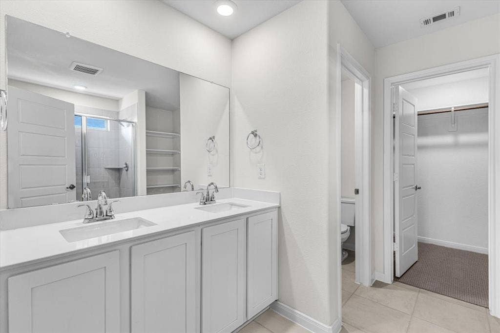 108 Timber Drive, Caddo Mills, TX 75135 Elegant master bathroom with dual sinks, large shower, and private toilet area