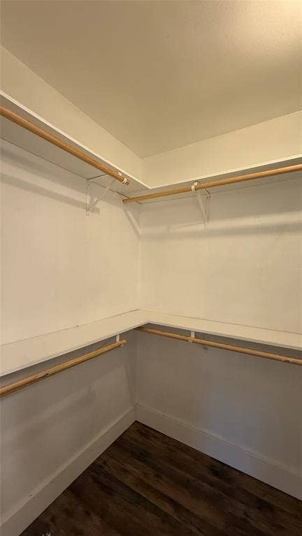8513 Ravenswood Road, Granbury, TX 76049 Wood-finish flooring with white walls and built-in closet shelving and hanging rods
