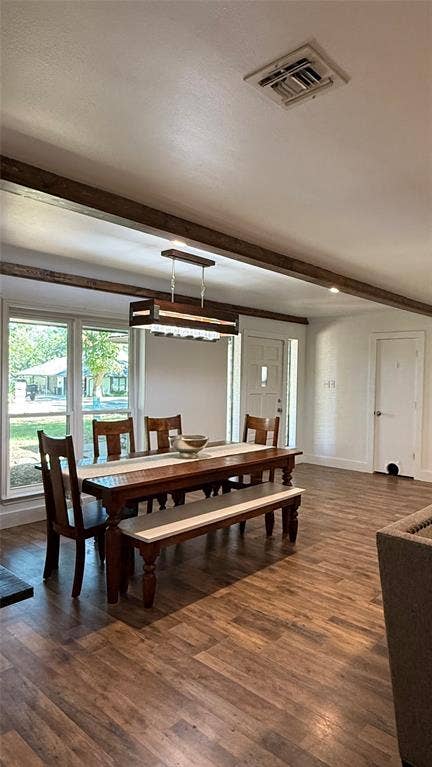 8513 Ravenswood Road, Granbury, TX 76049 Wood-finish flooring, exposed ceiling beams, recessed lighting, and a contemporary linear chandelier illuminate this space