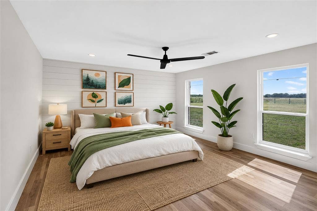 15166 FM 3133, Anna, TX 75409 Interior space featuring wood-finish flooring, a white shiplap accent wall, multiple windows, recessed lighting, and a ceiling fan - Virtually Staged