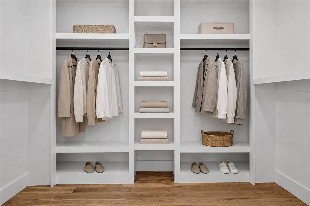 15166 FM 3133, Anna, TX 75409 Custom closet system featuring white built-in shelving, black hanging rods, and wood-finish flooring - Virtually Staged