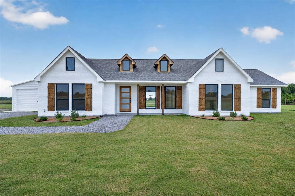 15166 FM 3133, Anna, TX 75409 White brick exterior with dark-framed windows and wood-finish shutters