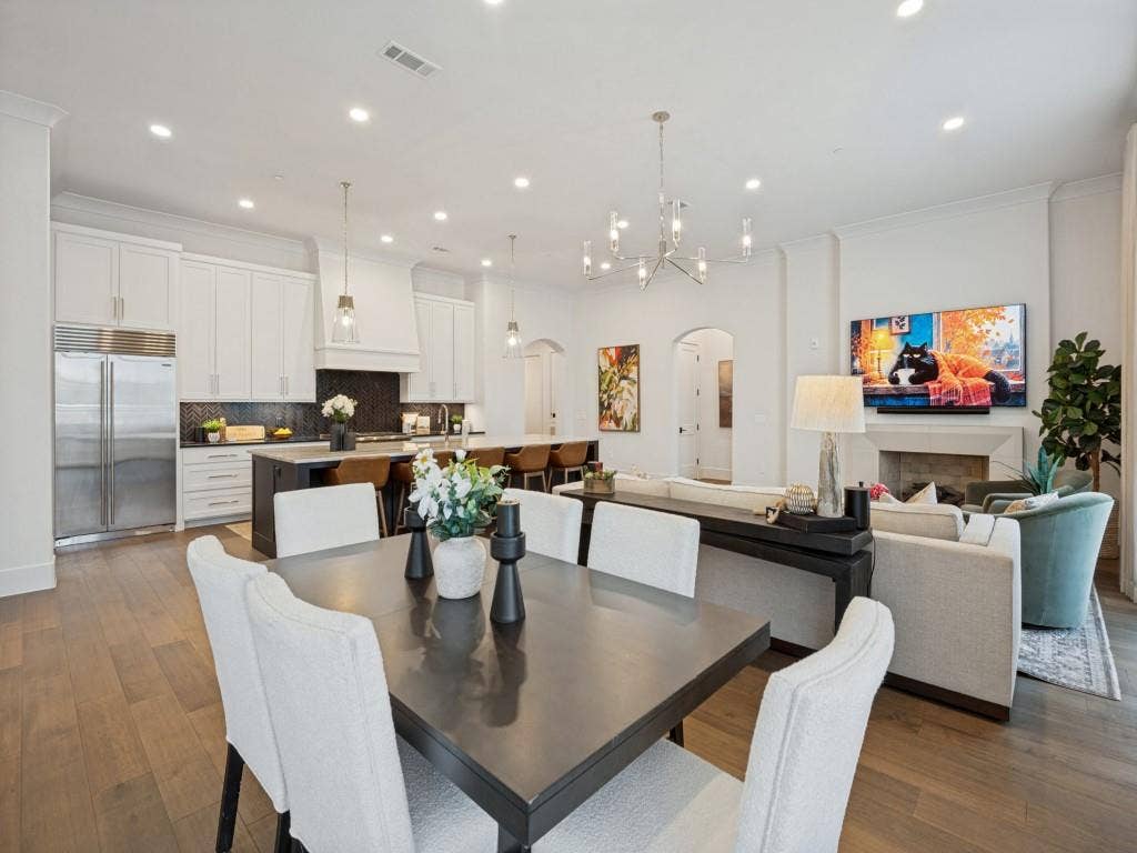 6801 Corporate Drive, #C2, Plano, TX 75024 The dining area is open to the living room and kitchen with beautiful light fixtures and plenty of room for entertaining.