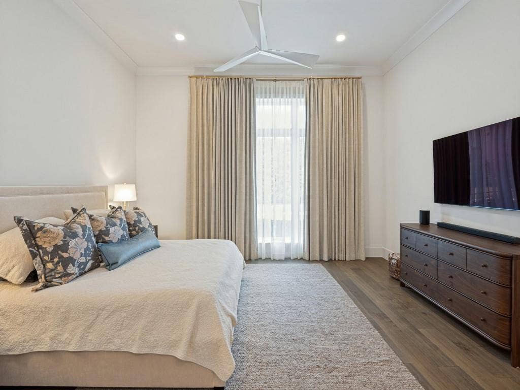6801 Corporate Drive, #C2, Plano, TX 75024 Primary bedroom features good natural light and a modern ceiling fan.