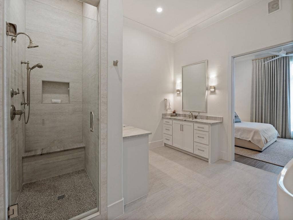 6801 Corporate Drive, #C2, Plano, TX 75024 The walk in shower is large with a bench, hand held sprayer or shower head, and a convenient niche for products.