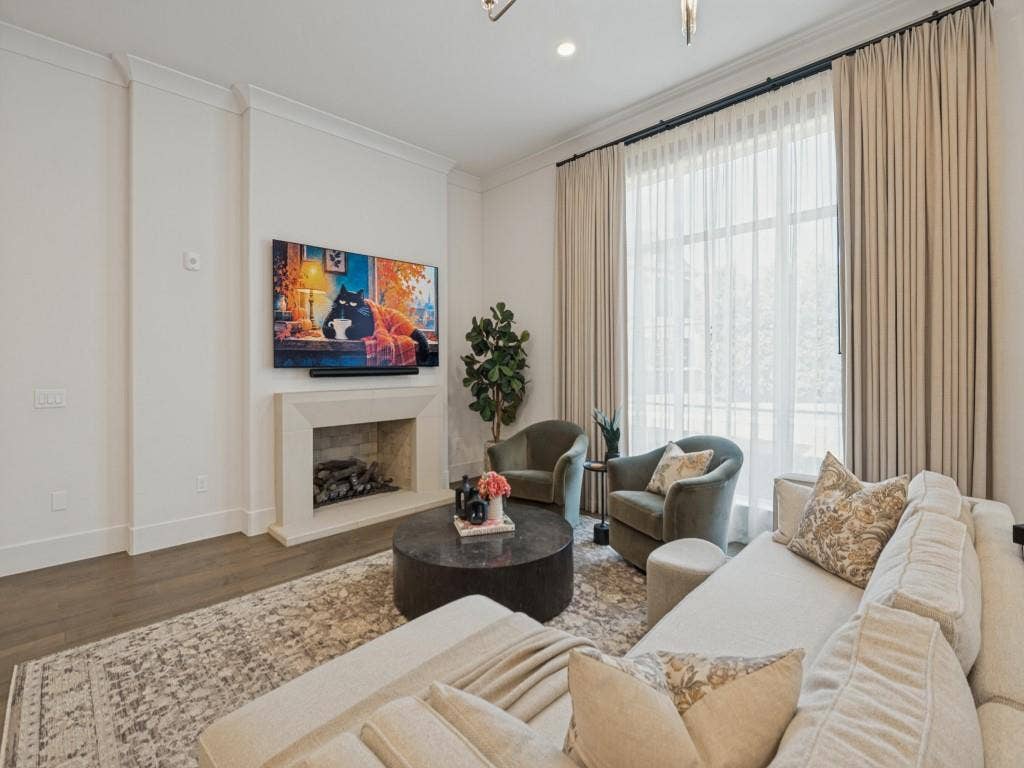 6801 Corporate Drive, #C2, Plano, TX 75024 The beautiful cast stone fireplace is equipped with gas logs, and the TV mount above offers a perfect spot for viewing.