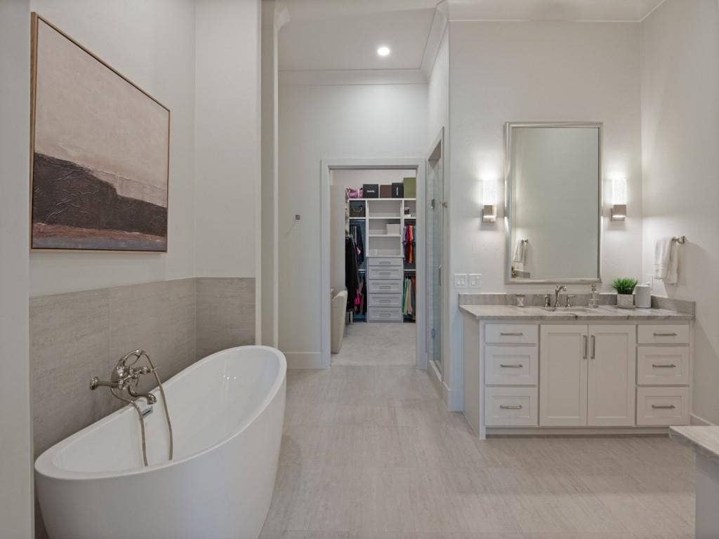 6801 Corporate Drive, #C2, Plano, TX 75024 This photo shows how much room there is between the vanities and bath area that leads to the shower and closet.