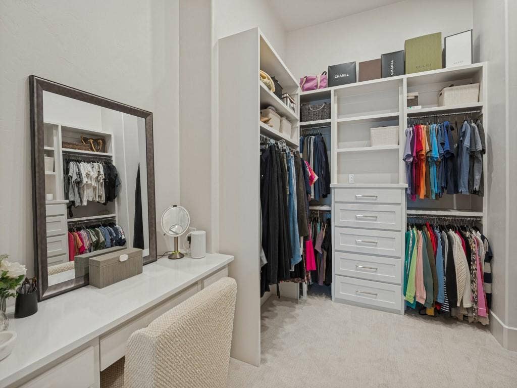 6801 Corporate Drive, #C2, Plano, TX 75024 The primary closet is a room within itself. A lovely make-up vanity and lots of room with shelving and drawers.