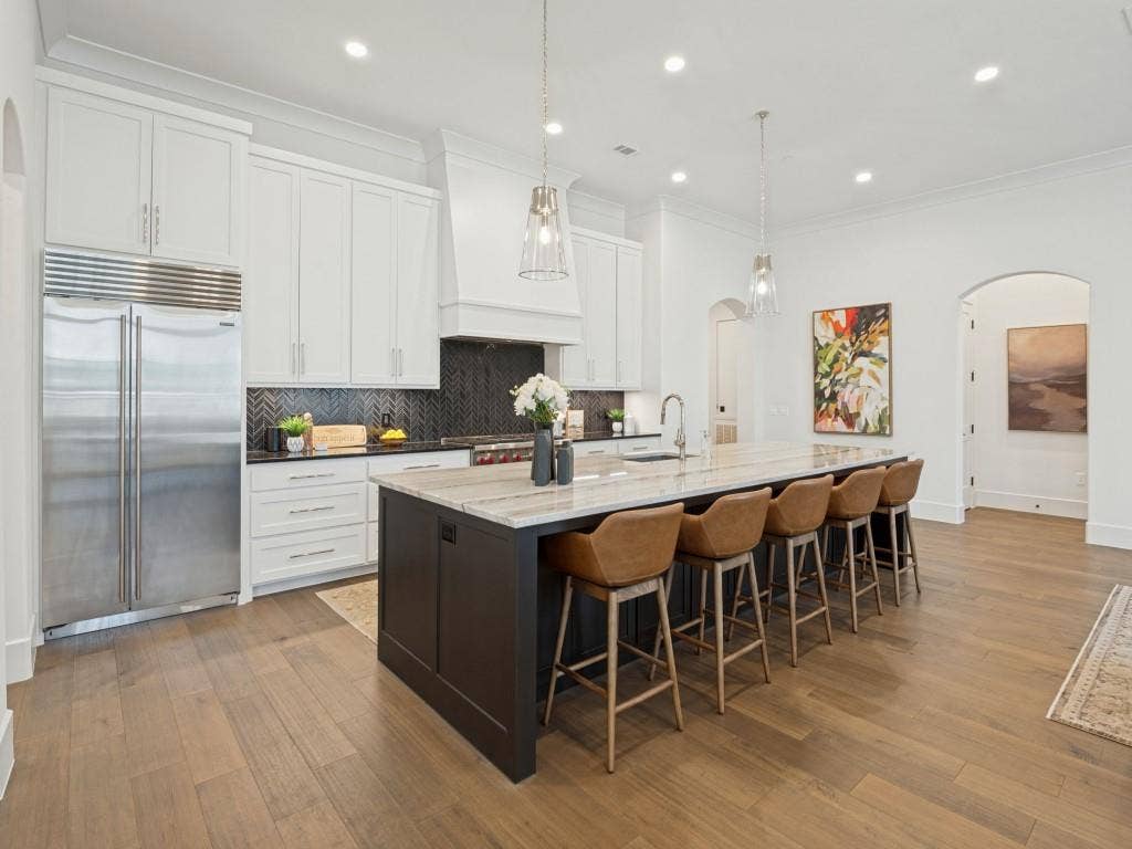 6801 Corporate Drive, #C2, Plano, TX 75024 The kitchen features wonderful built in appliances including a 48" Wolf gas range with grill, and a large built in refrigerator/freezer. Lots of cabinets for storage and a walk in pantry.