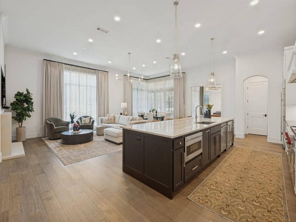 6801 Corporate Drive, #C2, Plano, TX 75024 The kitchen island also houses the built-in microwave, and beverage cooler as well as a pull out trash can.