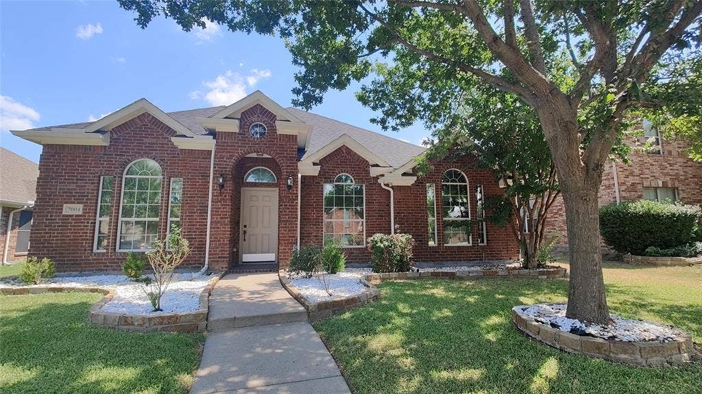 7004 Canyonbrook Drive, Plano, TX 75074 Brick exterior with arched windows, prominent gables, and a mature shade tree