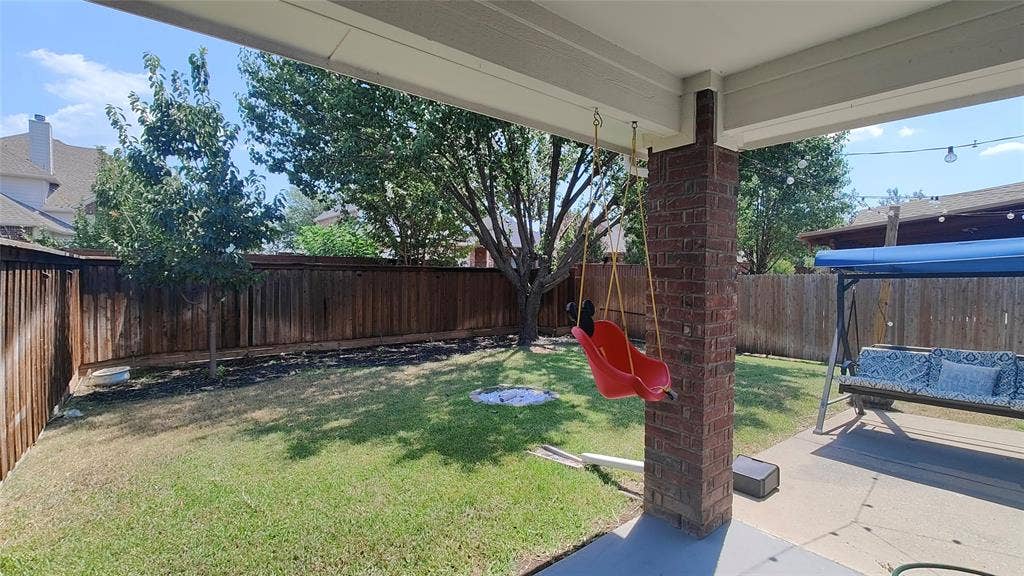 7004 Canyonbrook Drive, Plano, TX 75074 Covered patio featuring a brick column and concrete flooring