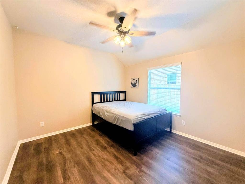 7004 Canyonbrook Drive, Plano, TX 75074 Vaulted ceiling with a ceiling fan, wood-finish flooring, and a window with horizontal blinds