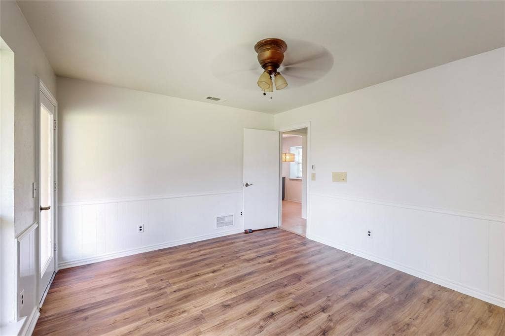 Wood-finish flooring with white wainscoting and trim