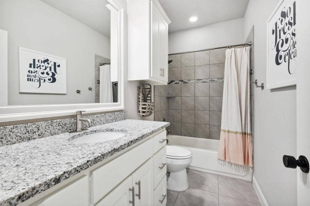 White vanity with an integrated sink and light-toned countertop