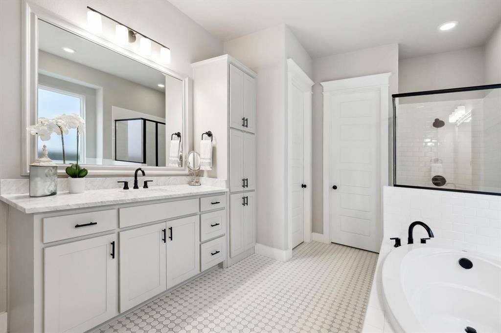 Dual vanity with white cabinetry, matte black fixtures, built-in storage, and a white countertop