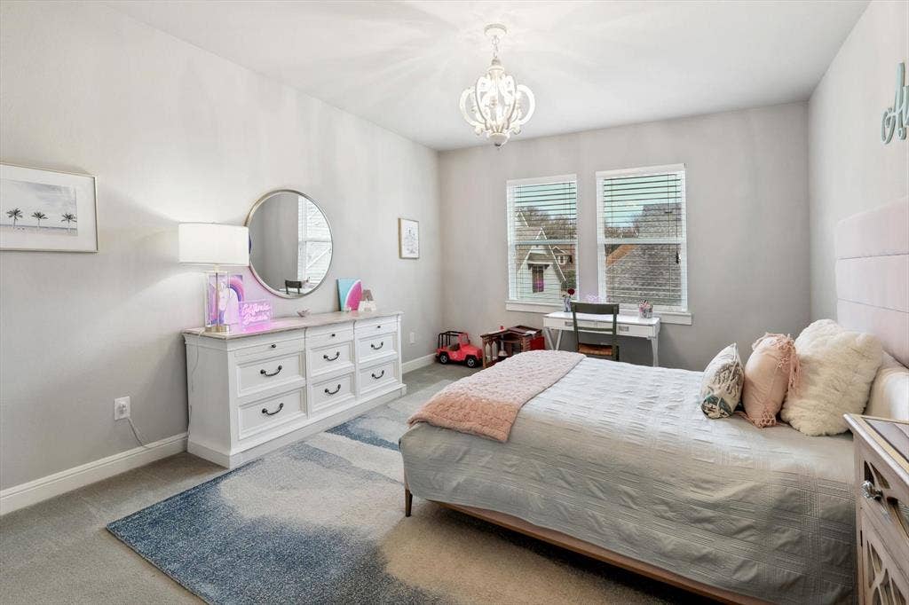 Recessed lighting and a decorative chandelier illuminate this room