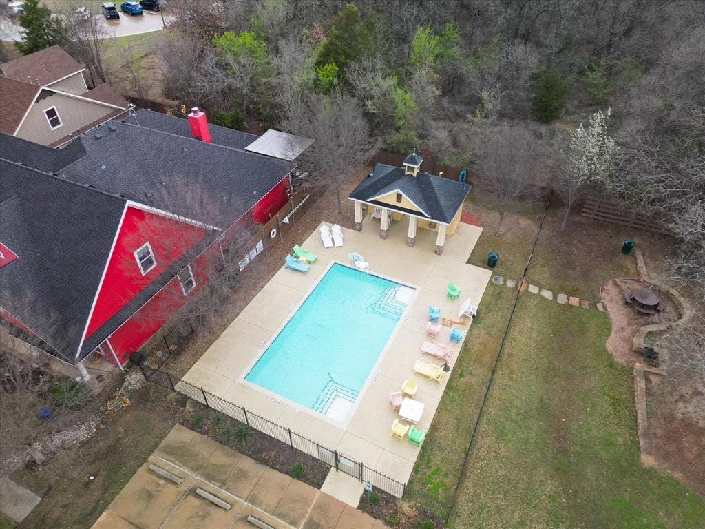 Rectangular swimming pool with integrated steps, surrounded by a paved deck