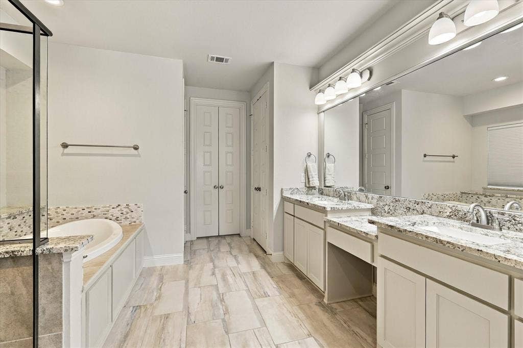 The primary bath has dual sinks and vanity counter