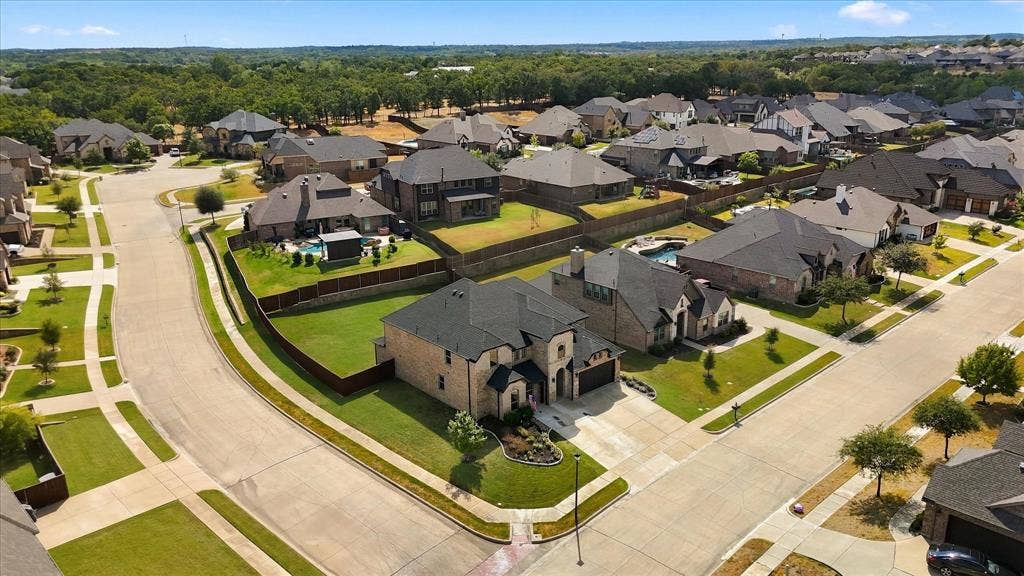 Another aerial view shows the lot and wood fencing