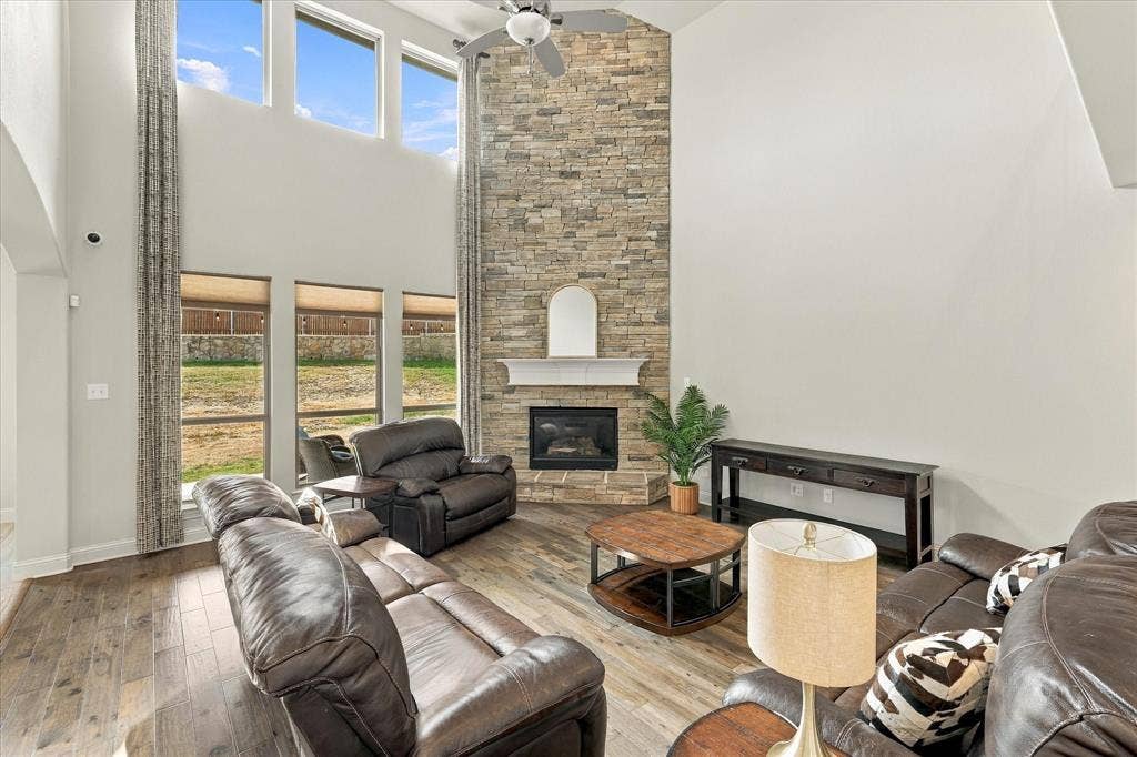 The grand fireplace highlights the tall ceiling in this living room