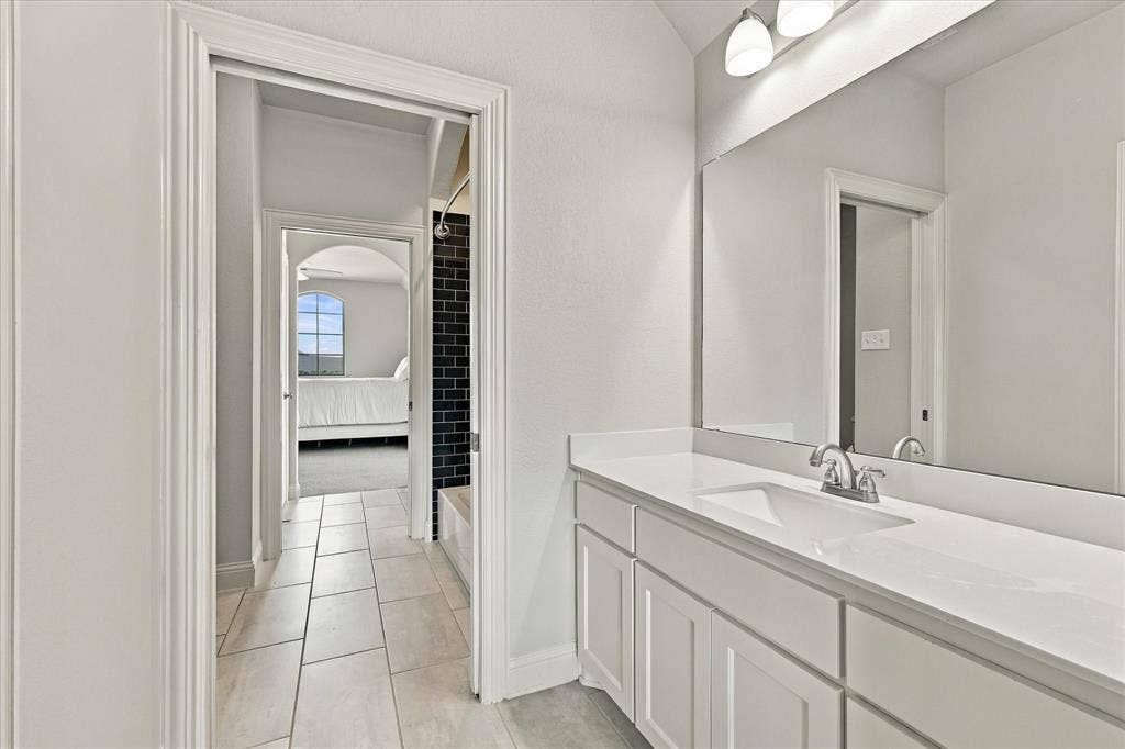 The jack-and-jill have separate vanities and privacy offered by pocket doors