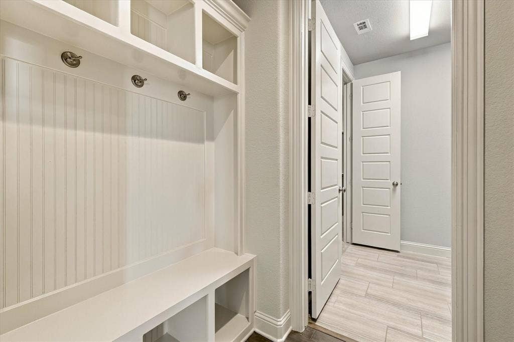 The mudroom with cubbies is just inside the garage entrance