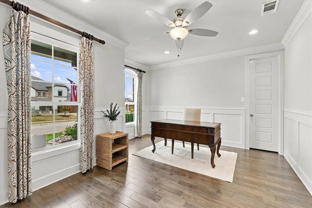 The large office has beautiful windows and a walk-in closet