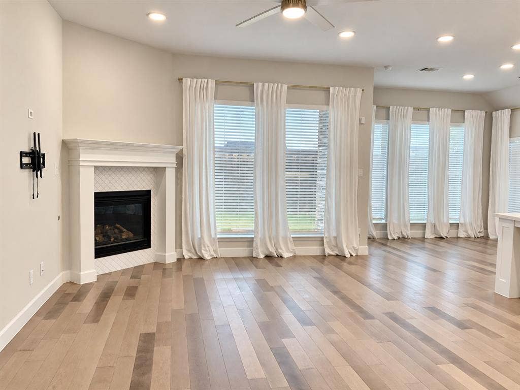 2234 Somercrest Place, Midlothian, TX 76065 Wood-finish flooring, recessed lighting, and a corner fireplace with a tiled surround