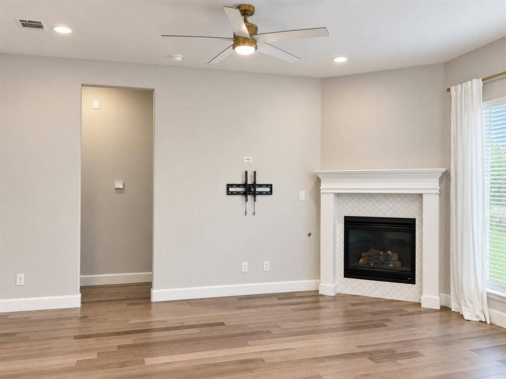 2234 Somercrest Place, Midlothian, TX 76065 Fireplace with a white mantel and patterned tile surround