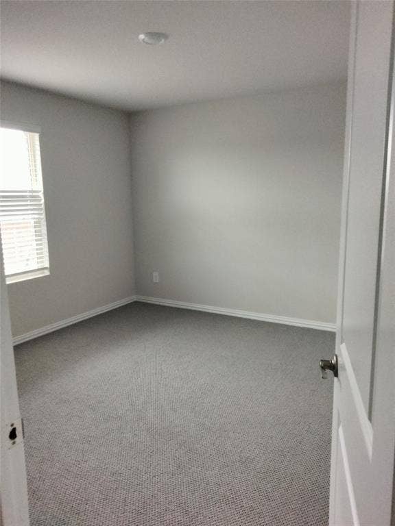 601 Willet Drive, McKinney, TX 75069 Neutral tone wall paint, grey textured carpet, white trim, recessed ceiling light, and a window with blinds