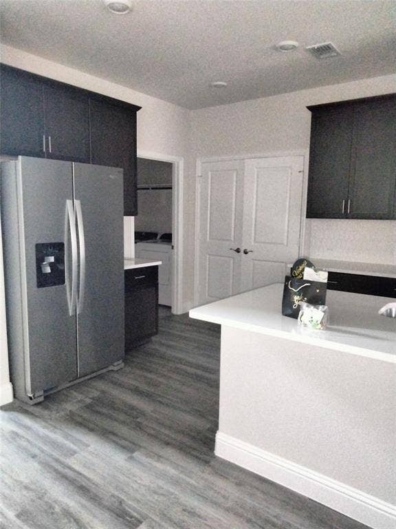 601 Willet Drive, McKinney, TX 75069 Wood-finish flooring, dark cabinetry, white countertops, recessed lighting, and a double-door entry