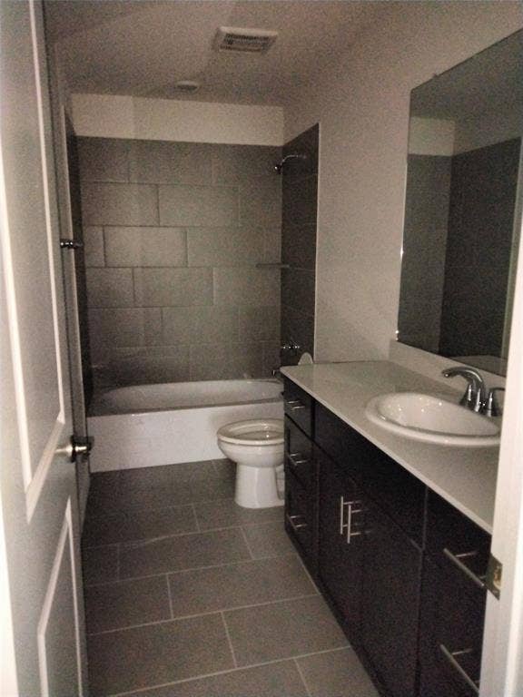 601 Willet Drive, McKinney, TX 75069 Bathroom featuring a full-size tub, subway tile shower surround, single vanity with integrated sink, and an expansive mirror