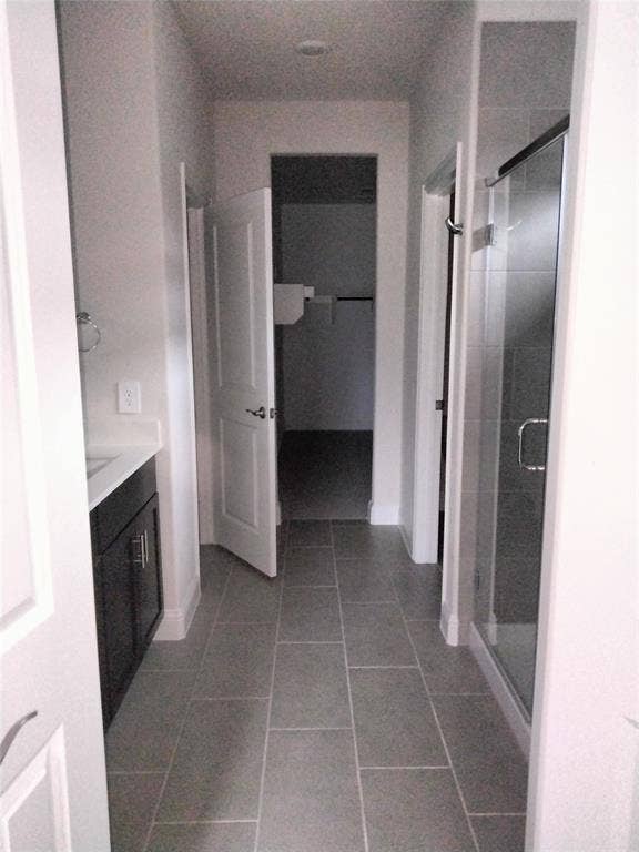 601 Willet Drive, McKinney, TX 75069 Tile flooring, dark wood-finish vanity, white countertop, glass-enclosed shower, recessed lighting