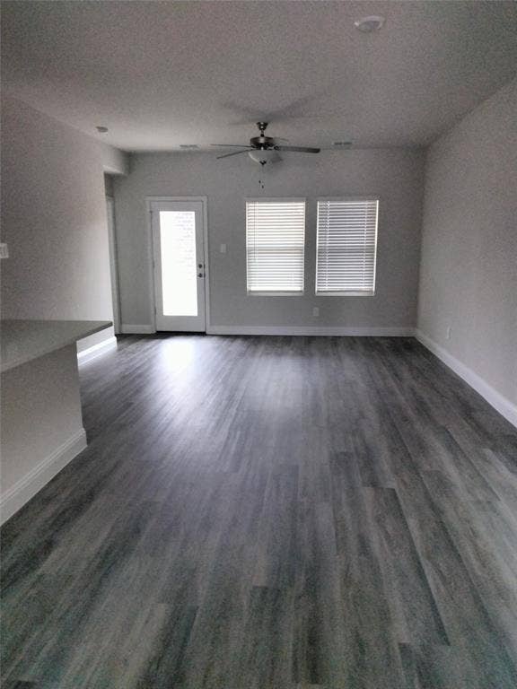 601 Willet Drive, McKinney, TX 75069 Wood-finish flooring, ceiling fan, white trim, recessed lighting, and multiple windows with blinds