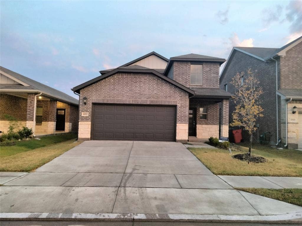 601 Willet Drive, McKinney, TX 75069 Brick and stone facade with an attached two-car garage
