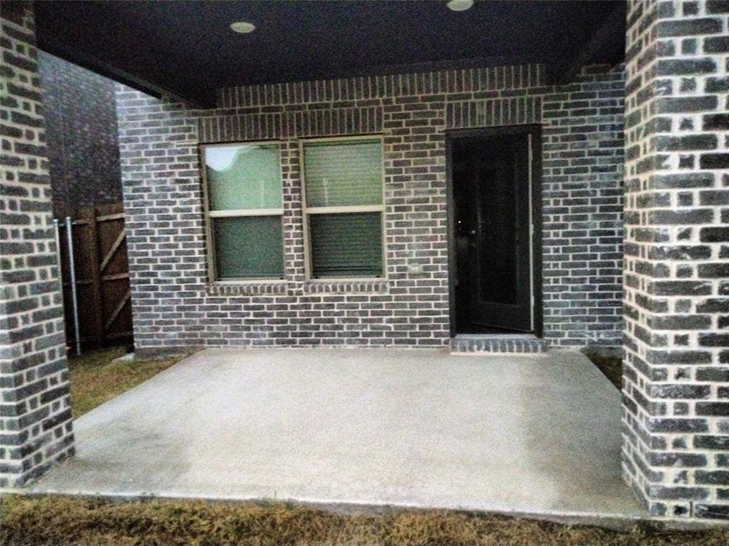 601 Willet Drive, McKinney, TX 75069 Concrete patio featuring a dark brick exterior, recessed lighting, and a dark-framed entry door