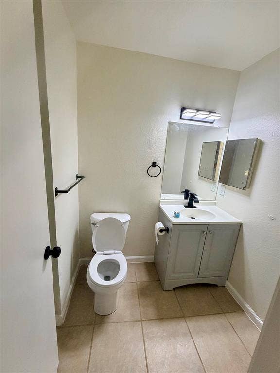 Vanity with cabinet storage, integrated sink, and black-finish faucet