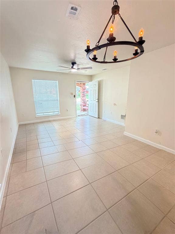Tile flooring, ceiling fan, window blinds, and a decorative chandelier