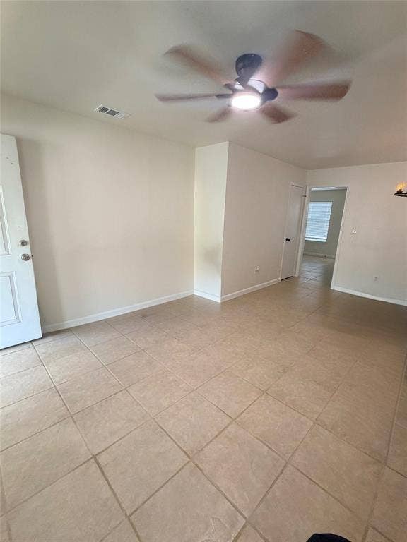 Ceiling fan with integrated lighting, tile flooring, and neutral wall tones