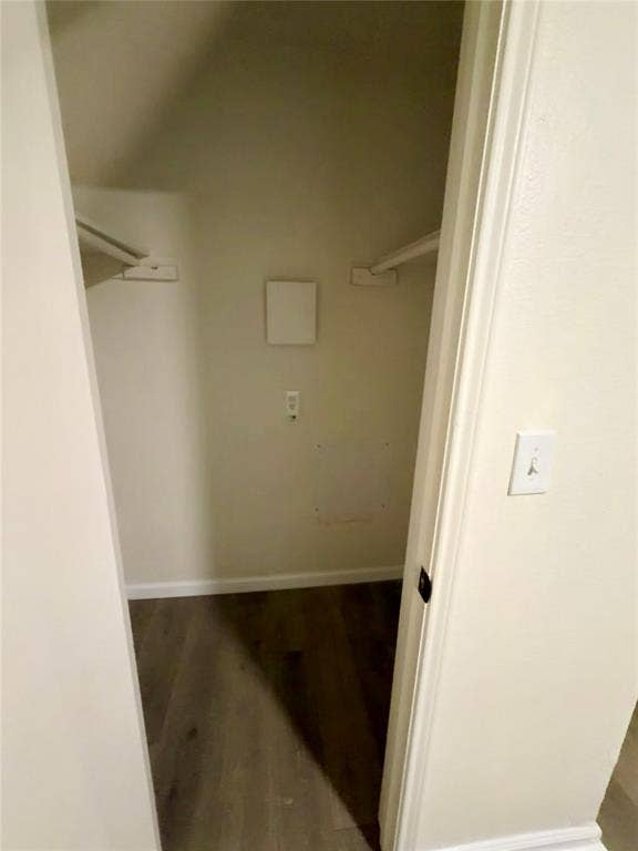 Built-in shelving brackets and wood-finish flooring in a recessed storage area