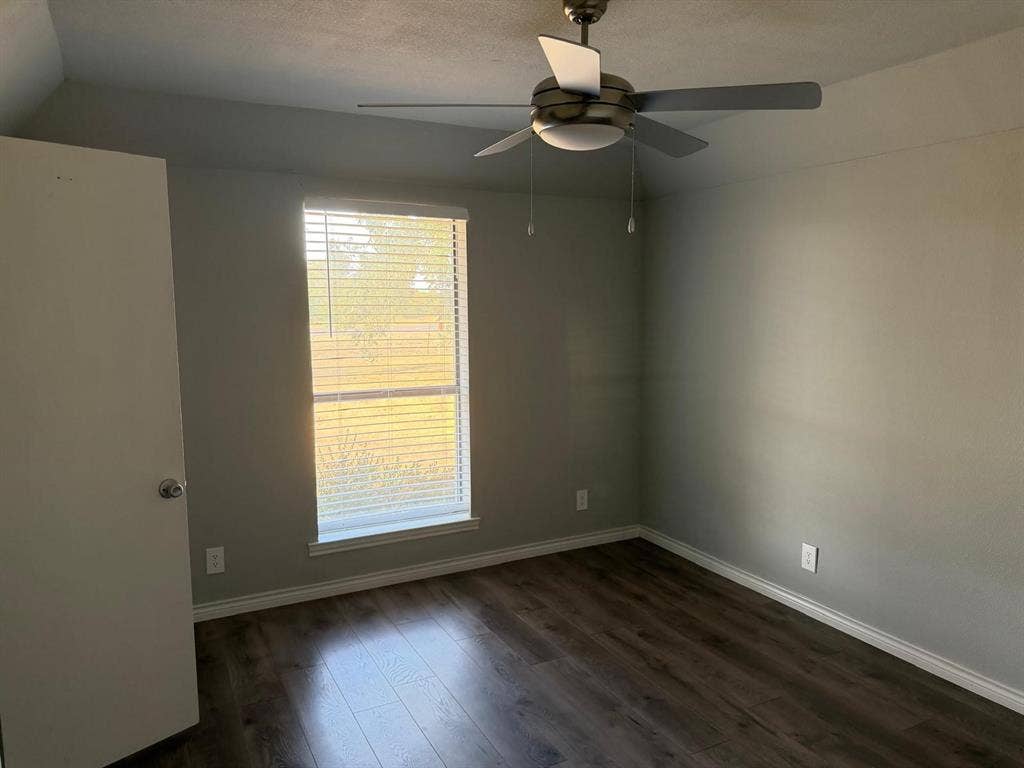 2928 Almeta Lane, McKinney, TX 75069 Wood-finish flooring, neutral wall tones, window with horizontal blinds, and a ceiling fan with integrated lighting