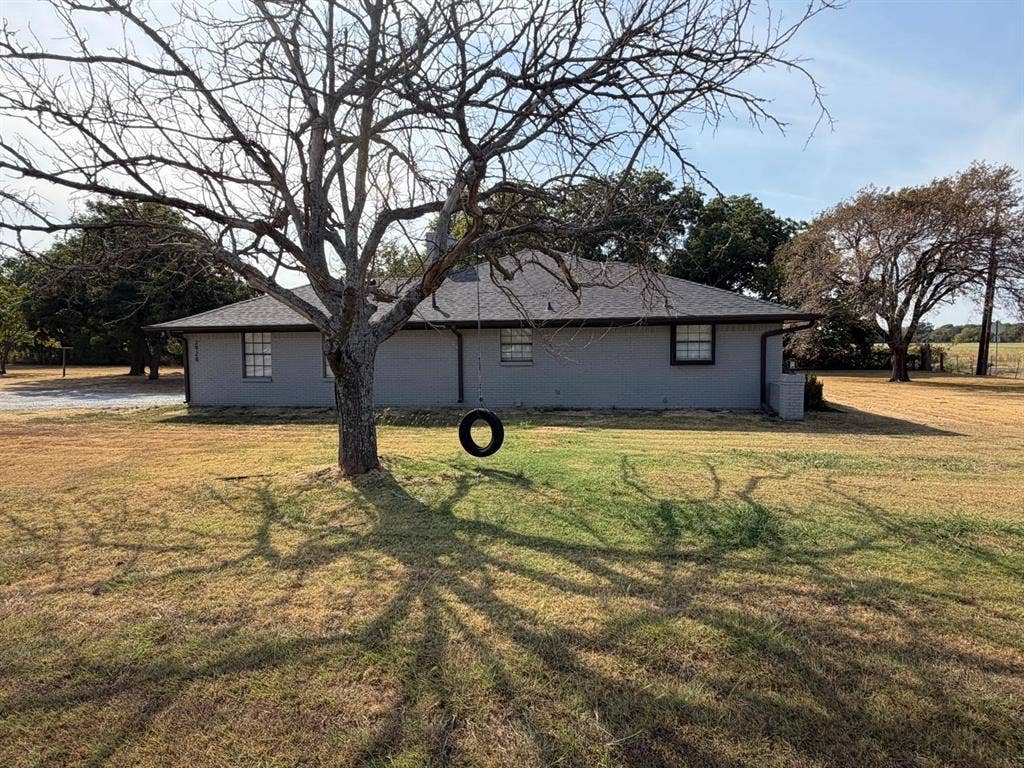 2928 Almeta Lane, McKinney, TX 75069 Gray exterior with white-framed windows, dark trim, and a dark shingle roof