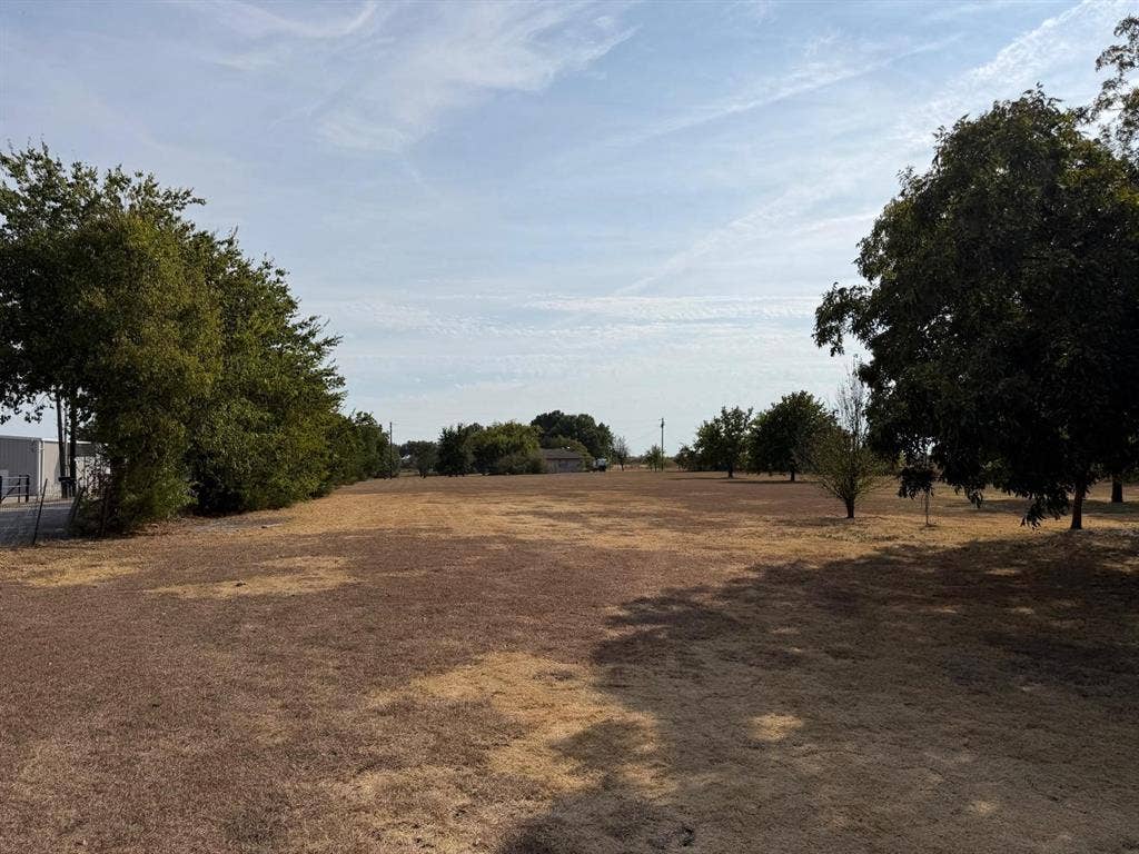 2928 Almeta Lane, McKinney, TX 75069 Expansive open land with scattered mature trees and distant structures