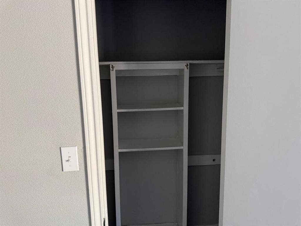 2928 Almeta Lane, McKinney, TX 75069 Built-in shelving unit with three storage compartments and an integrated hanging rod