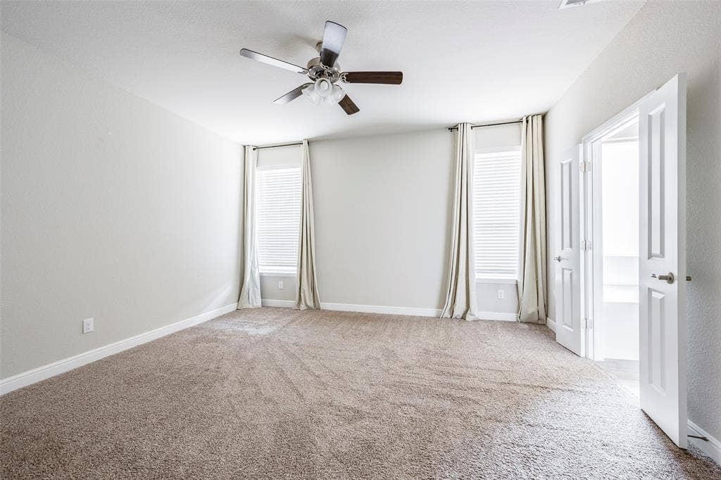 1548 Seabiscuit Drive, Granbury, TX 76049 Spacious room featuring neutral carpeting, light-toned walls, and a ceiling fan with integrated lighting